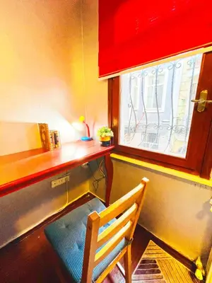 a desk with a chair in front of a window at Taksim Ottoman Style Hotel in Istanbul
