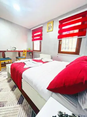a bedroom with a large bed with red accents at Taksim Ottoman Style Hotel in Istanbul