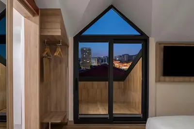 a room with a window with a view of a city at Hampton By Hilton Istanbul Merter in Istanbul