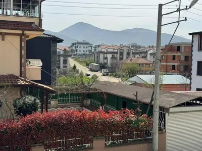 a view of a city with buildings and flowers at Luxurious 3BR Izmit Apartments- Mountain View in Çavuşçiftliği