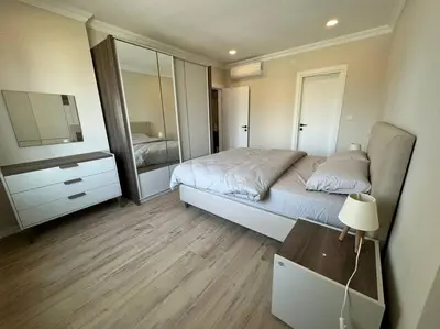 a bedroom with a bed and a dresser and a mirror at Luxurious 3BR Izmit Apartments- Mountain View in Çavuşçiftliği