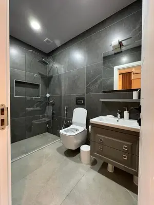 a bathroom with a toilet and a sink and a shower at Luxurious 3BR Izmit Apartments- Mountain View in Çavuşçiftliği
