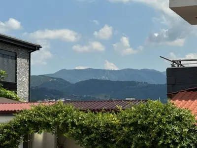 a view of mountains from the roofs of buildings at Luxurious 3BR Izmit Apartments- Mountain View in Çavuşçiftliği