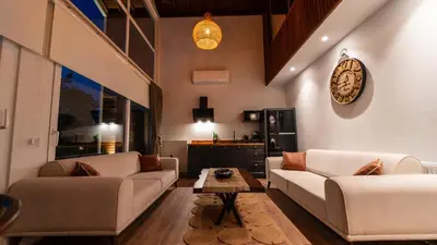 a living room with two couches and a table at Trio Palazio Sapanca in Sapanca