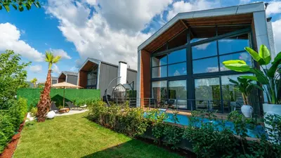 a house with a garden and a swimming pool at Trio Palazio Sapanca in Sapanca