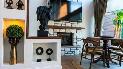 a living room with a fireplace and a tv at Trio Palazio Sapanca in Sapanca