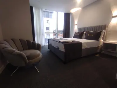 a bedroom with a bed and a chair and a window at Cevvo Hotel Pendik in Istanbul