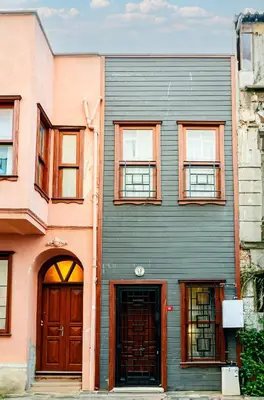 a building with brown doors and windows on a street at The Wall Private Mansion Kumkapı in Istanbul