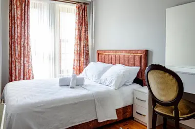 a bedroom with a bed with a chair and a window at The Wall Private Mansion Kumkapı in Istanbul