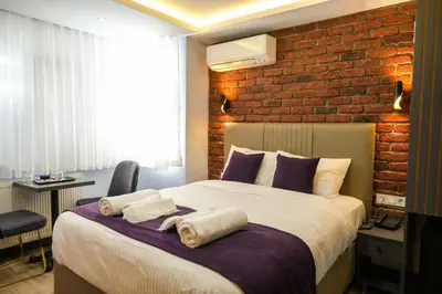 a bedroom with a large bed with a brick wall at mansion yellow hotel in Istanbul