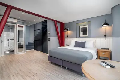 a bedroom with a bed and a table in a room at Urban Quarters - Loft in Istanbul