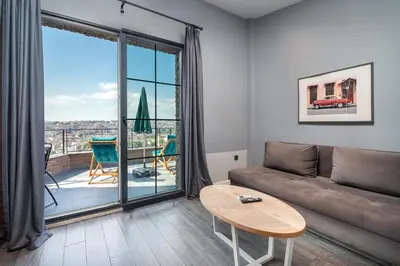 a living room with a couch and a table at Urban Quarters - Loft in Istanbul