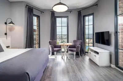 a bedroom with a bed and a table and chairs at Urban Quarters - Loft in Istanbul