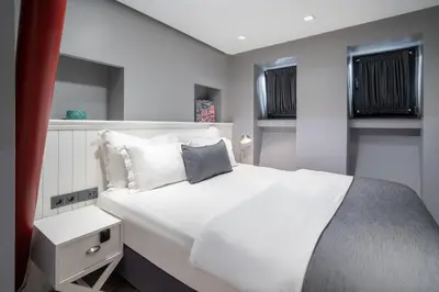 a bedroom with a large bed with white sheets and pillows at Urban Quarters - Loft in Istanbul