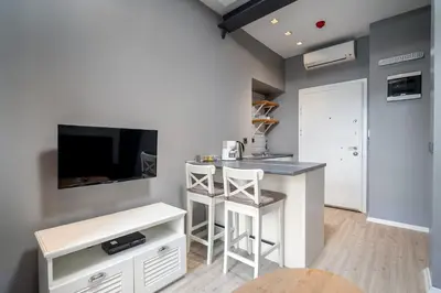 a small kitchen with a bar and a tv at Urban Quarters - Loft in Istanbul