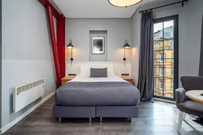 a hotel room with a bed and a chair at Urban Quarters - Loft in Istanbul
