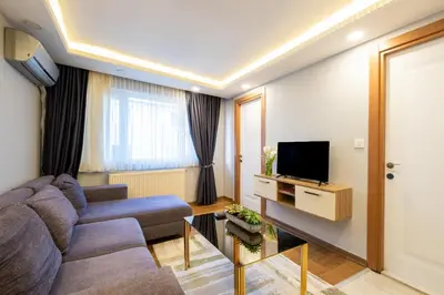 a living room with a couch and a tv at Fulya Süit Hotel in Istanbul