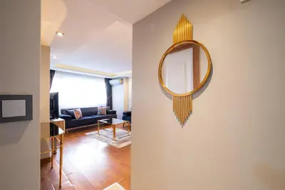 a mirror on the wall of a living room at Fulya Süit Hotel in Istanbul