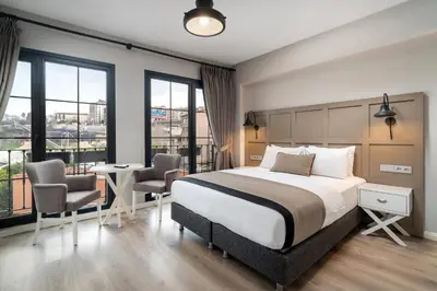 a bedroom with a bed and a table and chairs at Urban Quarters - Tepebaşı in Istanbul