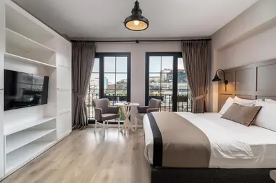 a bedroom with a bed and a table with chairs at Urban Quarters - Tepebaşı in Istanbul
