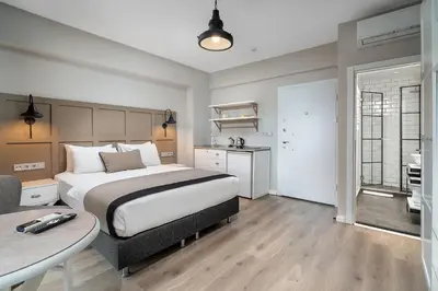 a bedroom with a large bed and a table in it at Urban Quarters - Tepebaşı in Istanbul