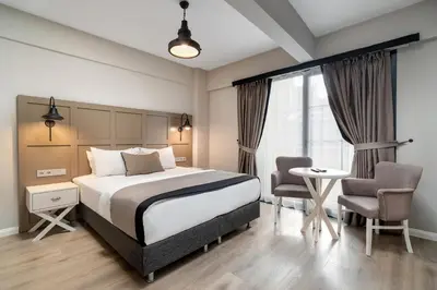a bedroom with a bed and a table and chairs at Urban Quarters - Tepebaşı in Istanbul
