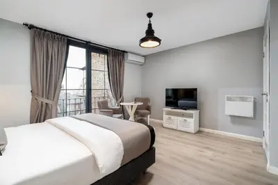 a bedroom with a large bed and a television at Urban Quarters - Tepebaşı in Istanbul
