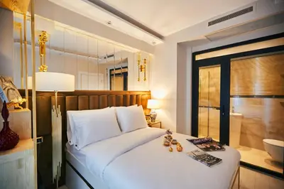 a bedroom with a large white bed and a bathroom at Mitspark in Istanbul