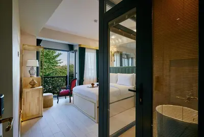 a bedroom with a bed and a balcony at Mitspark in Istanbul