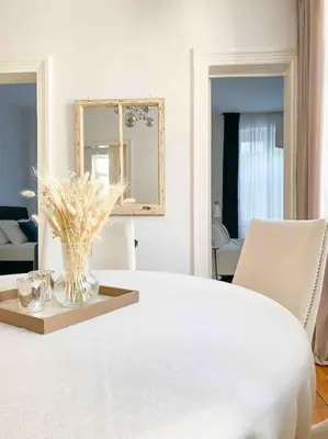 a white room with a table with a vase of flowers at Charming historical apartment in Galata in Istanbul