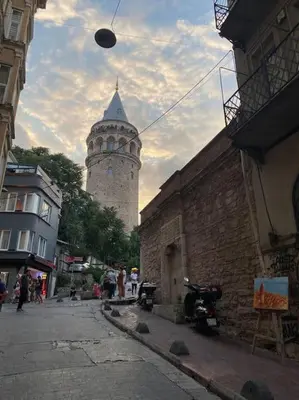 a tall building with a clock tower in the background at Charming historical apartment in Galata in Istanbul
