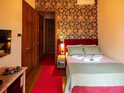 a bedroom with a large bed with a red wall at Araz White House in Burgaz