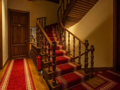 a staircase in a house with a red carpet at Araz White House in Burgaz