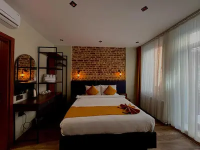 a bedroom with a large bed and a brick wall at Galata Calm Tale Hotel in Istanbul