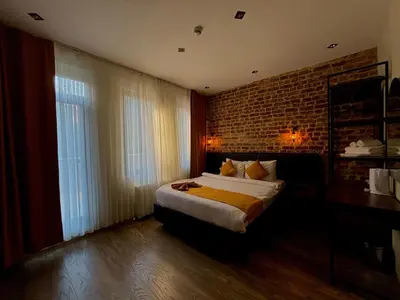 a bedroom with a bed and a brick wall at Galata Calm Tale Hotel in Istanbul