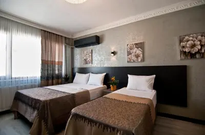 a hotel room with two beds and a window at Gzh Park Bosphorus in Istanbul