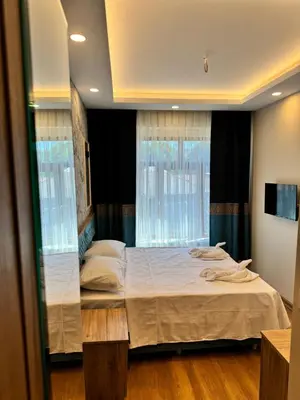 a bedroom with two beds and a window at Riverside Hotel in Istanbul