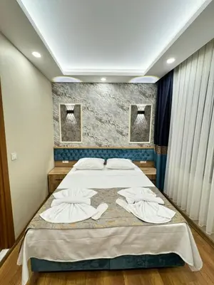 a bedroom with a large bed with towels on it at Riverside Hotel in Istanbul