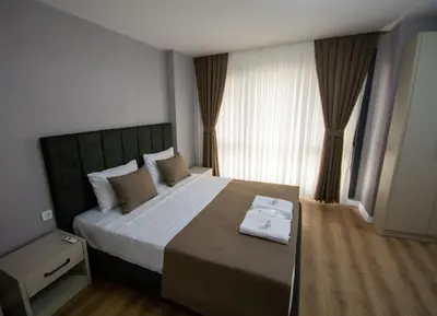 a bedroom with a large bed with a large window at Luxury Life Suites in Istanbul