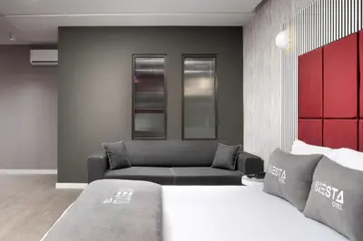 a living room with a couch and a bed at Siesta Hotel Bakırköy in Istanbul