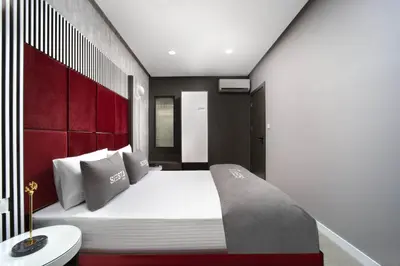 a bedroom with a large bed with a red headboard at Siesta Hotel Bakırköy in Istanbul