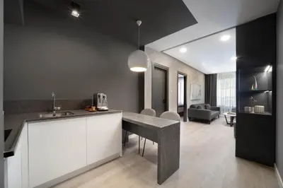a kitchen with a counter top and a living room at Siesta Hotel Bakırköy in Istanbul
