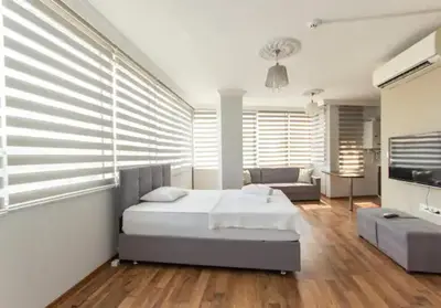 a bedroom with a bed and a living room at Zeplin Otel in Istanbul