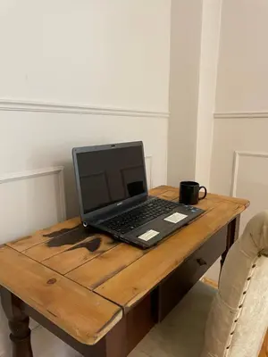 a laptop computer sitting on top of a wooden table at Fatih Balatta Pink Home 3 in Istanbul