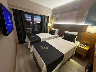 a hotel room with two beds and a television at The Best Hotel İstanbul in Istanbul