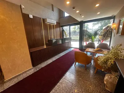 a lobby with a table and chairs and a kitchen at The Best Hotel İstanbul in Istanbul