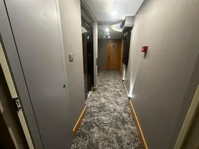 a corridor of a hallway with a long corridorngth at The Best Hotel İstanbul in Istanbul