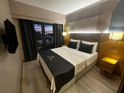 a bedroom with a large bed with a large window at The Best Hotel İstanbul in Istanbul