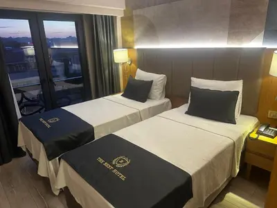 two beds in a hotel room with a view at The Best Hotel İstanbul in Istanbul