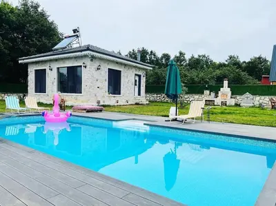a swimming pool with a pink flamingo in front of a house at MEDASUİTE Stone House With Pool And Jacuzzi in Kandıra